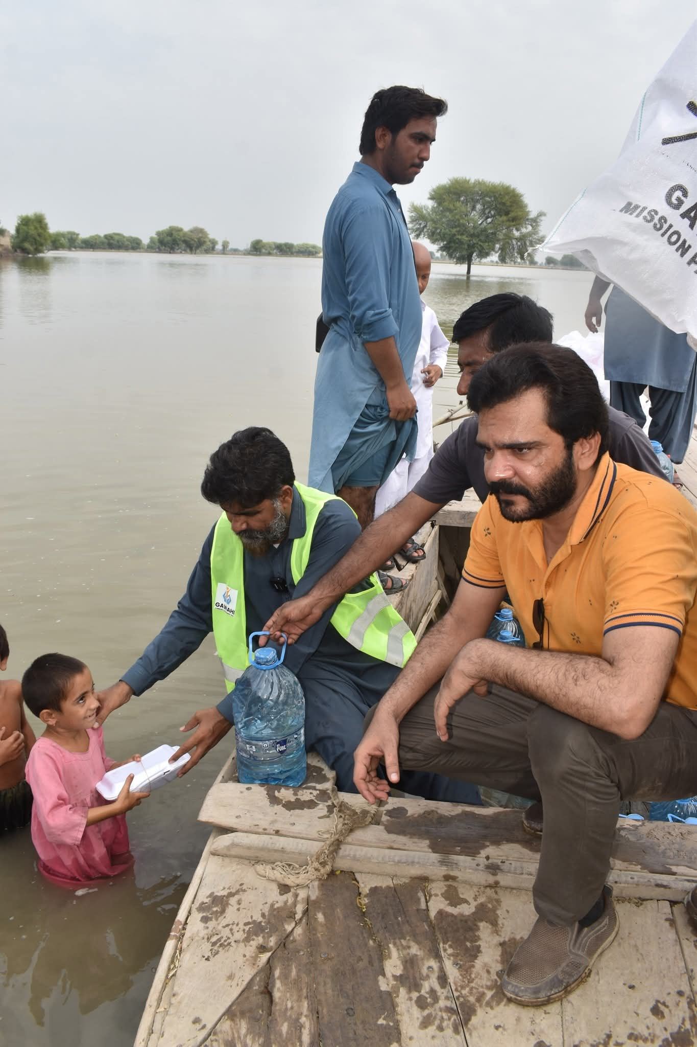 ZDO team reaching a flooded village by boat with food and water