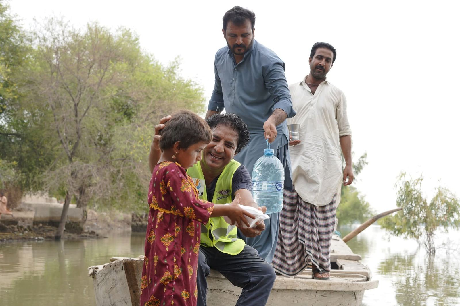 A child receives a warm meal during flood relief