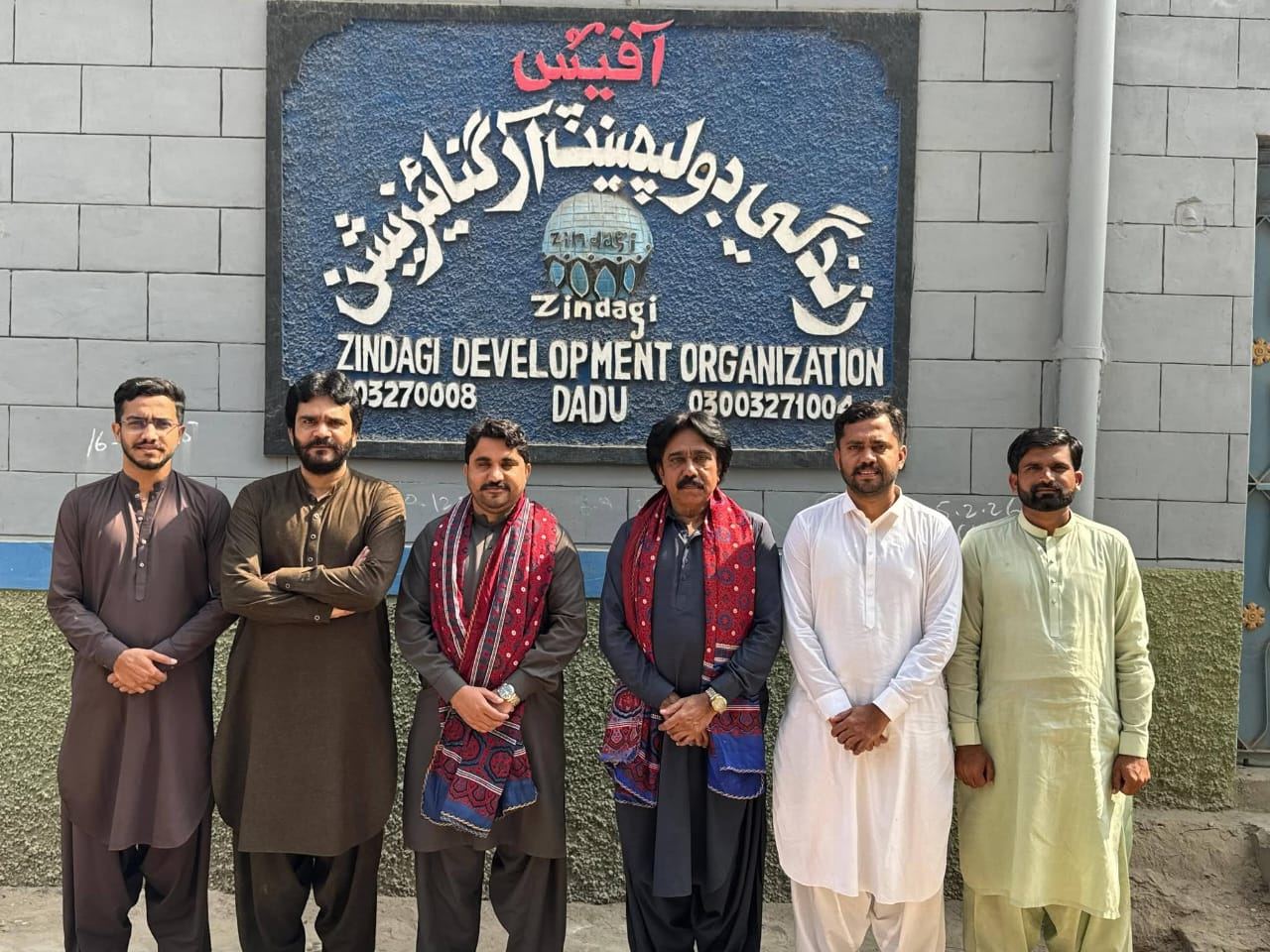ZDO team outside the office signboard