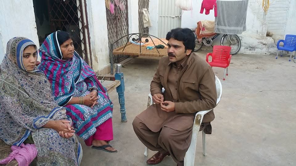 ZDO founder engaging with a family supported through the PWD program
